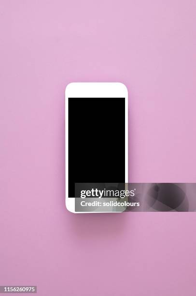 smart phone on pink - phone coloured background stock pictures, royalty-free photos & images