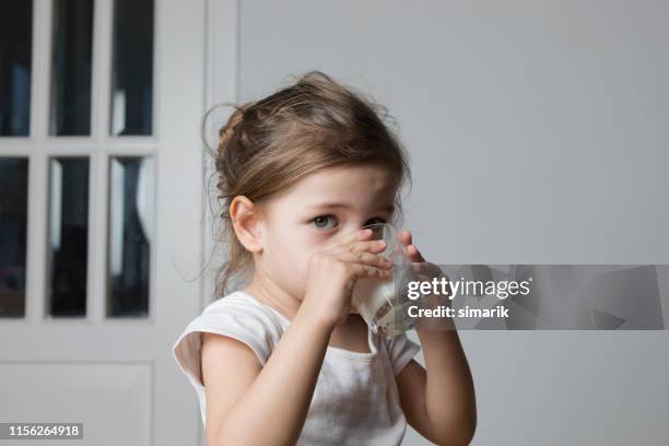 kids milk - girl drinking milk stock pictures, royalty-free photos & images