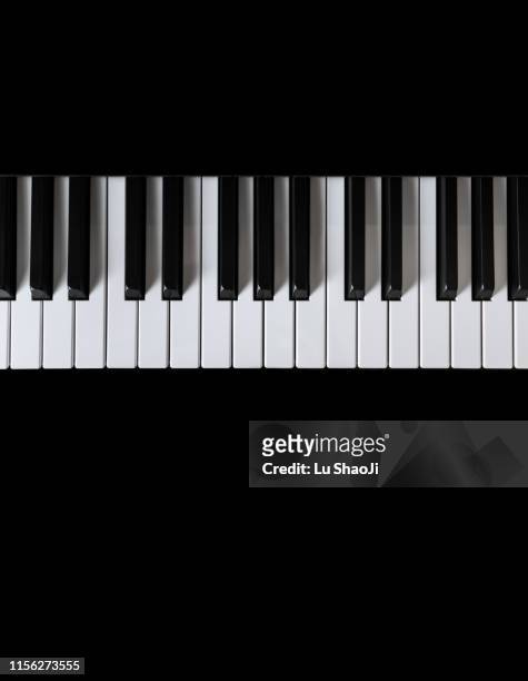 piano and piano keyboard with black backgrounds - classical music background stock-fotos und bilder