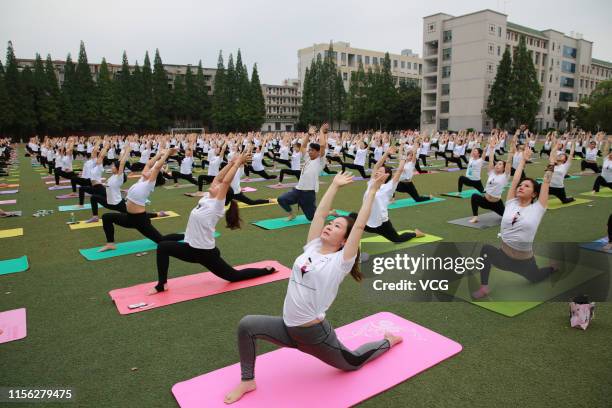 Hundreds of yoga enthusiasts practice Yoga at a school ahead of International Day of Yoga on June 16, 2019 in Xiangyang, Hubei Province of China.