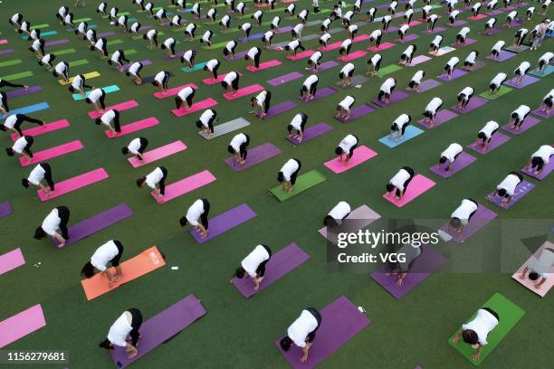 Hundreds of yoga enthusiasts practice Yoga at a school ahead of International Day of Yoga on June 16, 2019 in Xiangyang, Hubei Province of China.