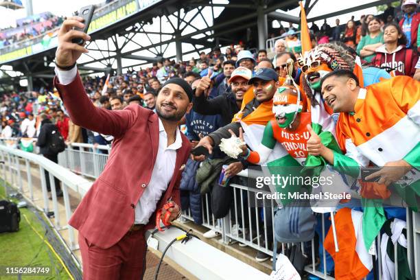 Ex India cricketer Harbhajan Singh takes a selfie with India supporters during the Group Stage match of the ICC Cricket World Cup 2019 between India...