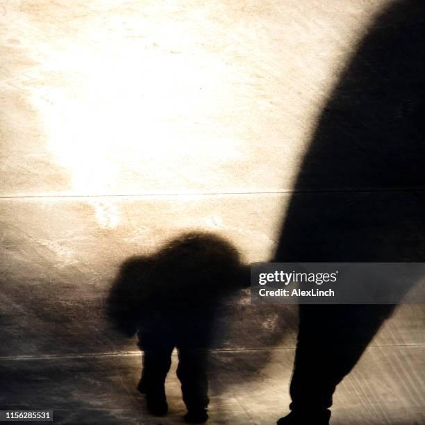 Vintage blurry shadow of a boy and an adult walking