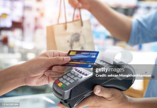 close up of a card payment being made betweem a man and a waiter in a cafe. - small restaurant stock pictures, royalty-free photos & images