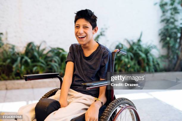 smiling teenager with celebral palsy in wheelchair - learning difficulty stock pictures, royalty-free photos & images