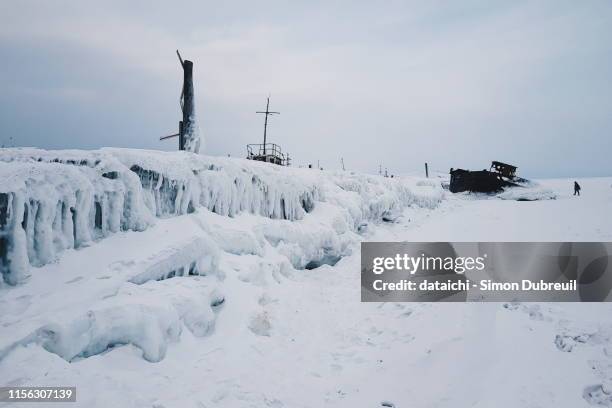 ice formations on the old wooden pier of khuzhir - gulag stock pictures, royalty-free photos & images