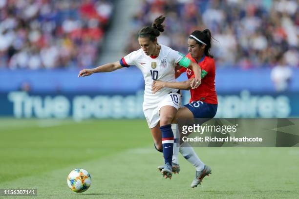 Carli Lloyd of the USA is challenged by Su Helen Galaz of Chile during the 2019 FIFA Women's World Cup France group F match between USA and Chile at...