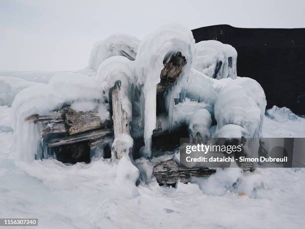 ice formations on the old wooden pier of khuzhir - gulag stock pictures, royalty-free photos & images