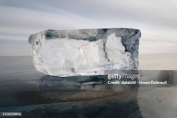 rectangular and pure block of ice on lake baikal in winter - 氷　塊 ストックフォトと画像