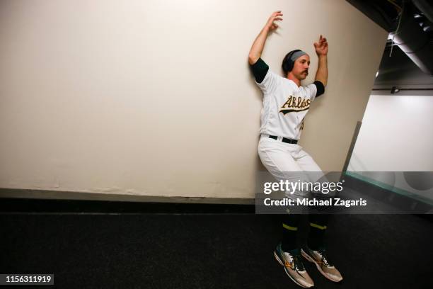 Daniel Mengden of the Oakland Athletics stretches in the hallway prior to the game against the Los Angeles Angels of Anaheim at the Oakland-Alameda...