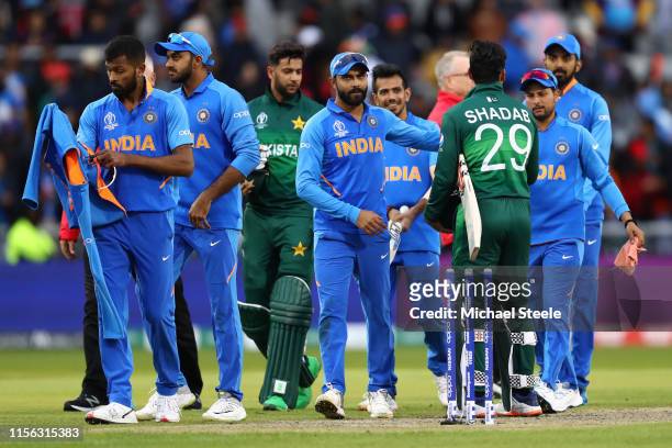 Virat Kohli the captain of India shakes hands with Shadab Khan of Pakistan after his side's 89 run win on D/L Method during the Group Stage match of...