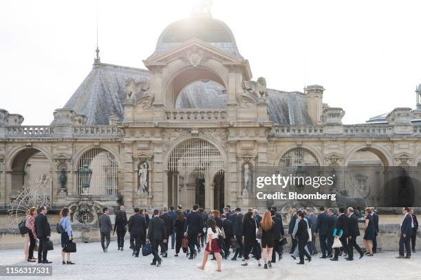 Group of Seven finance ministers, central bank governors and their entourage walk into Chateau de Chantilly after posing for a group photograph...