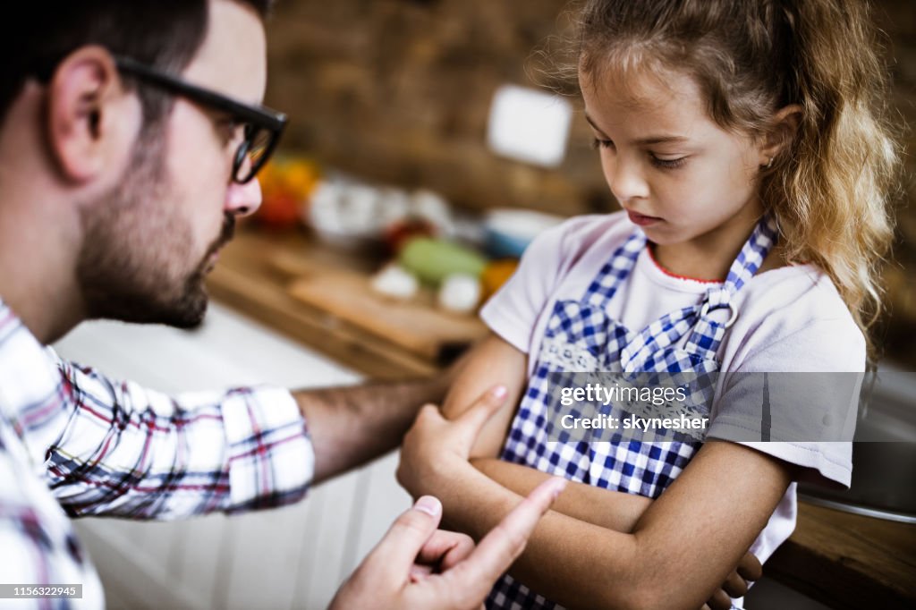 Father scolding his daughter at home.