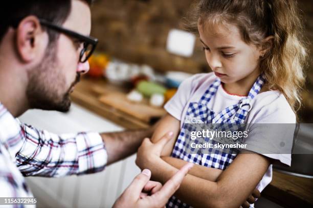 father scolding his daughter at home. - scolding stock pictures, royalty-free photos & images