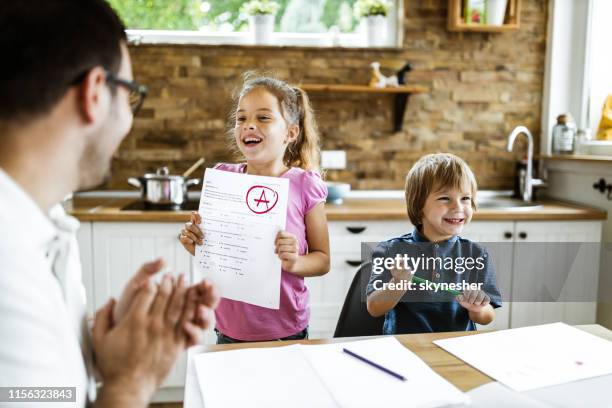 look daddy, i've got an a on my exam! - child report card stock pictures, royalty-free photos & images