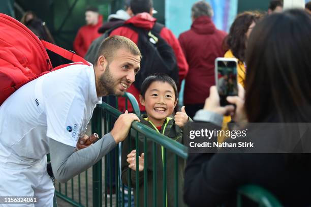 Daniel Evans of Great Britain signs autographs as he wins the match against Evgeny Donskoy of Russia during day seven of the Nature Valley Open at...