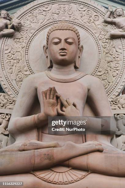 Sandstone statue of Lord Buddha turning the Wheel of Dharma displayed outside the Sri Dalada Museum of Buddhism located at the Temple of the Sacred...