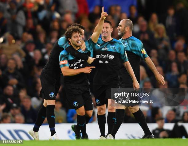 Kem Cetinay of Soccer Aid World XI celebrates after scoring his team's second goal with team mates during the Soccer Aid for UNICEF 2019 match...