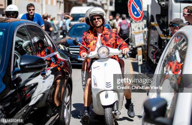 Couple Alice Barbier and Jean-Sebastian Rocques seen on a vespa outside Etro during the Milan Men's Fashion Week Spring/Summer 2020 on June 16, 2019...