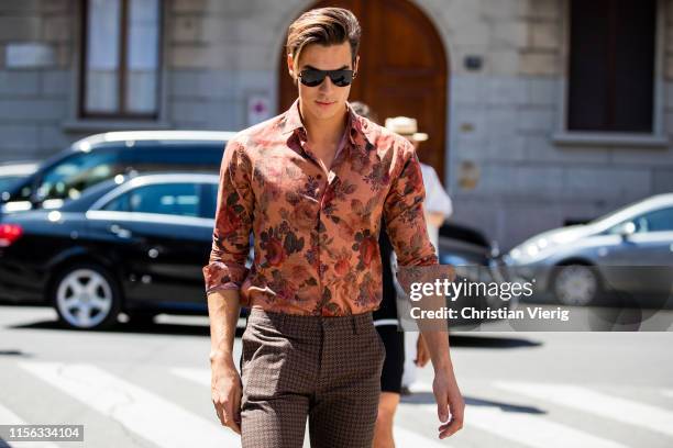 Guest is seen wearing button shirt with print outside Etro during the Milan Men's Fashion Week Spring/Summer 2020 on June 16, 2019 in Milan, Italy.