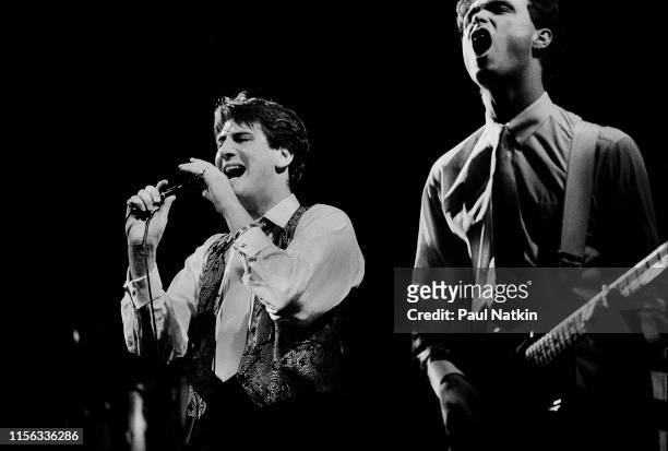English New Wave singer Tony Hadley and Gary Kemp, on guitar, both of the group Spandau Ballet, perform onstage at the Shubert Theatre, Chicago,...