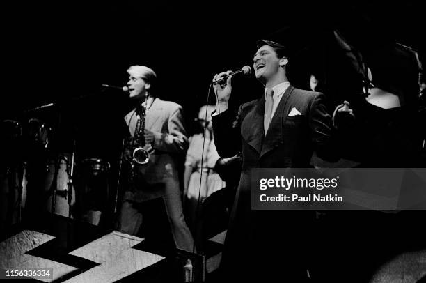 English New Wave musicians Steve Norman , on saxophone, and singer Tony Hadley, both of the group Spandau Ballet, perform onstage at the Shubert...