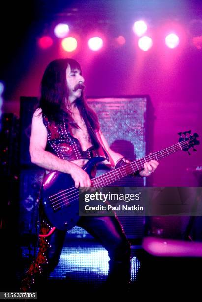 American comedian Harry Shearer, in costume as British musician Derek Smalls of the group Spinal Tap, plays bass guitar as he performs onstage during...