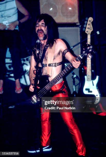 American comedian Harry Shearer, in costume as British musician Derek Smalls of the group Spinal Tap, plays bass guitar as he performs onstage at the...