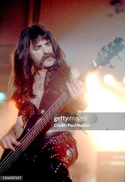 American comedian Harry Shearer, in costume as British musician Derek Smalls of the group Spinal Tap, plays bass guitar as he performs onstage during...