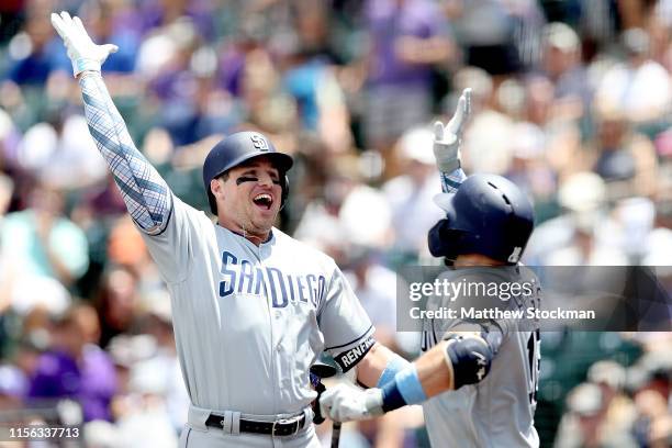 Hunter Renfroe of the San Diego Padres celebrates with Austin Hedges after hitting 2 RBI home run in the first inning against the Colorado Rockies at...