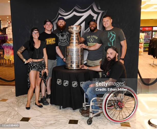Katlyn Govero, Kelly Pettus, Chris Robert, Michael Mosby, Chris Franklin and J.D. Hall, all of Missouri, pose with the Stanley Cup at MGM Grand Hotel...