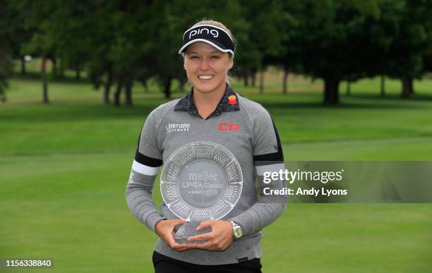 Brooke Henderson of Canada holds the winner's trophy after winning the Meijer LPGA Classic at Blythefield Country Club on June 16, 2019 in Grand...