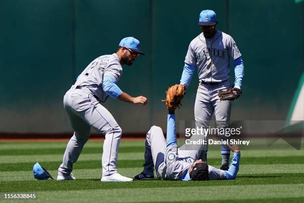 Crawford of the Seattle Mariners signals that he caught a fly ball for an out after colliding with Mac Williamson during the sixth inning against the...