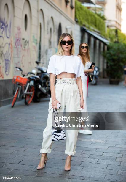 Chiara Capitani is seen wearing white cropped top, creme white pants, bag with zebra print outside Palm Angels during the Milan Men's Fashion Week...