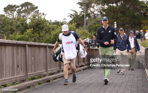 Matt Kuchar of the United States and caddie, John Wood, walk up the fifth hole during the final round of the 2019 U.S. Open at Pebble Beach Golf...