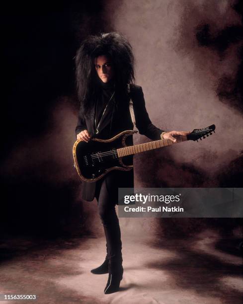 Portrait of American Rock musician Steve Stevens, with his guitar, as he poses in a photo studio, Chicago, Illinois, December 15, 1989.