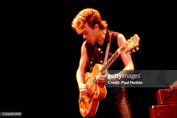 American Rockabilly musician Brian Setzer, of the group Stray Cats, plays guitar as he performs onstage at the Park West, Chicago, Illinois, October...