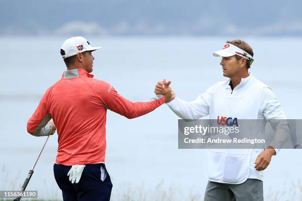 Gary Woodland of the United States and caddie, Brennan Little, celebrate on the 18th green after winning the 2019 U.S. Open at Pebble Beach Golf...