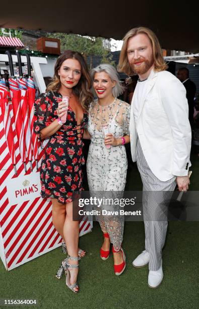 Candice Brown, Pips Taylor and Henry Conway celebrate the Pimm's Summer Garden at Flat Iron Square on July 18, 2019 in London, England.