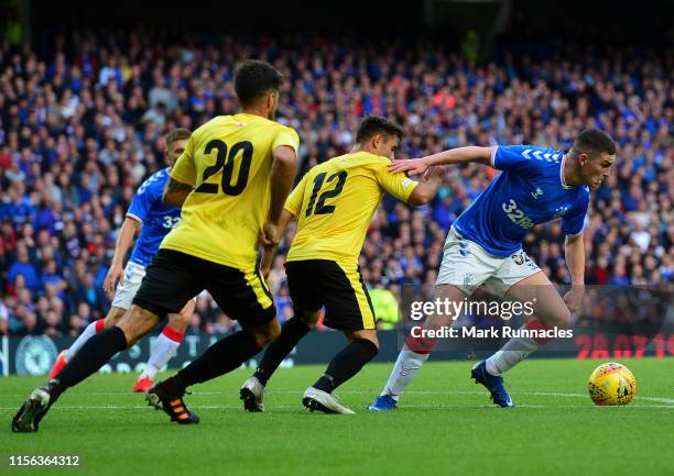 Jake Hastie of Rangers is challenged by Andrew Hernandez and Federico Martin Villar of St Joseph during the UEFA Europa League First Qualifying round...