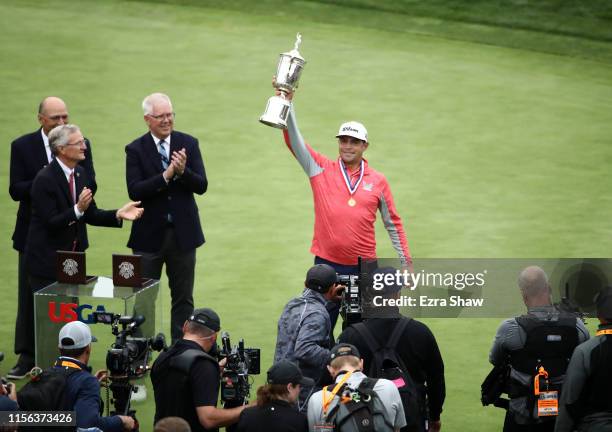 Gary Woodland of the United States celebrates with the trophy after winning the 2019 U.S. Open at Pebble Beach Golf Links on June 16, 2019 in Pebble...