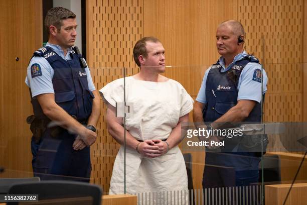 The man charged in relation to the Christchurch massacre, Brenton Tarrant, gestures in the dock for his appearance for murder in the Christchurch...