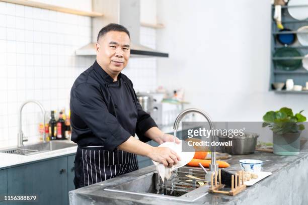 asian chef washing dish - wash the dishes stock pictures, royalty-free photos & images