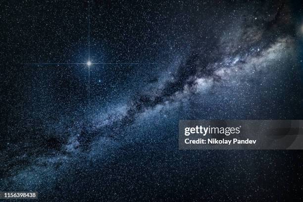 amazing spike glowing lucky star and milky way galaxy background - stock image - milky way stock pictures, royalty-free photos & images