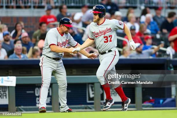 Stephen Strasburg celebrates with Bob Henley of the Washington Nationals in the third inning after hitting a three run home run during the game...