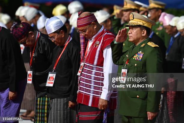 Myanmar's Army Chief Min Aung Hlaing salutes during the Martyrs' Day ceremony in Yangon on July 19, 2019. - Myanmar observes the 72nd anniversary of...