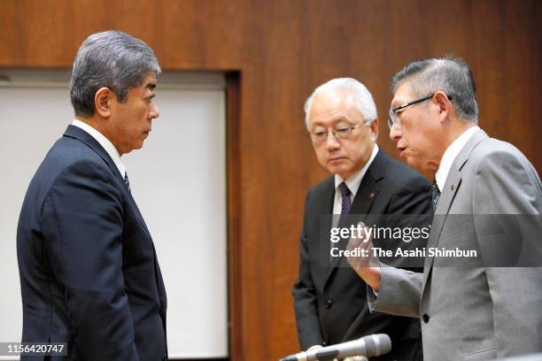 Defense Minister Takeshi Iwaya apologises to Akita Prefecture Governor Norihisa Satake during their meeting at the Akita Prefecture headquarters on...