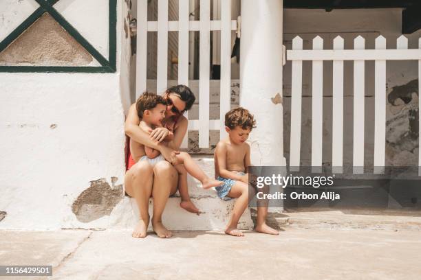 big brother fealing jelous while mother kisses brother - brother jealous stock pictures, royalty-free photos & images