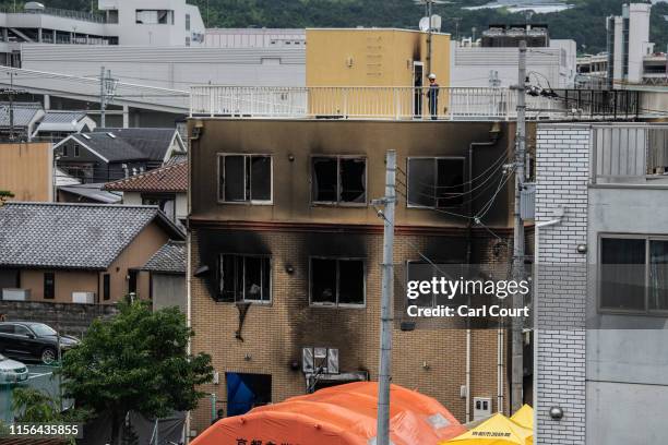 Emergency services personnel work at the Kyoto Animation Co studio building after an arson attack, on July 19, 2019 in Kyoto, Japan. Thirty three...