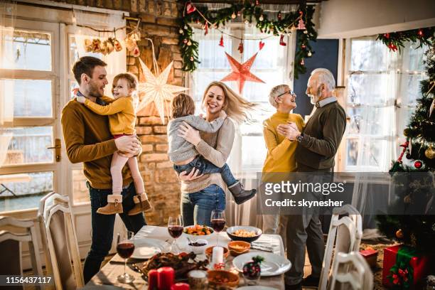 happy extended family dancing on new year's party at home. - family new year's eve stock pictures, royalty-free photos & images